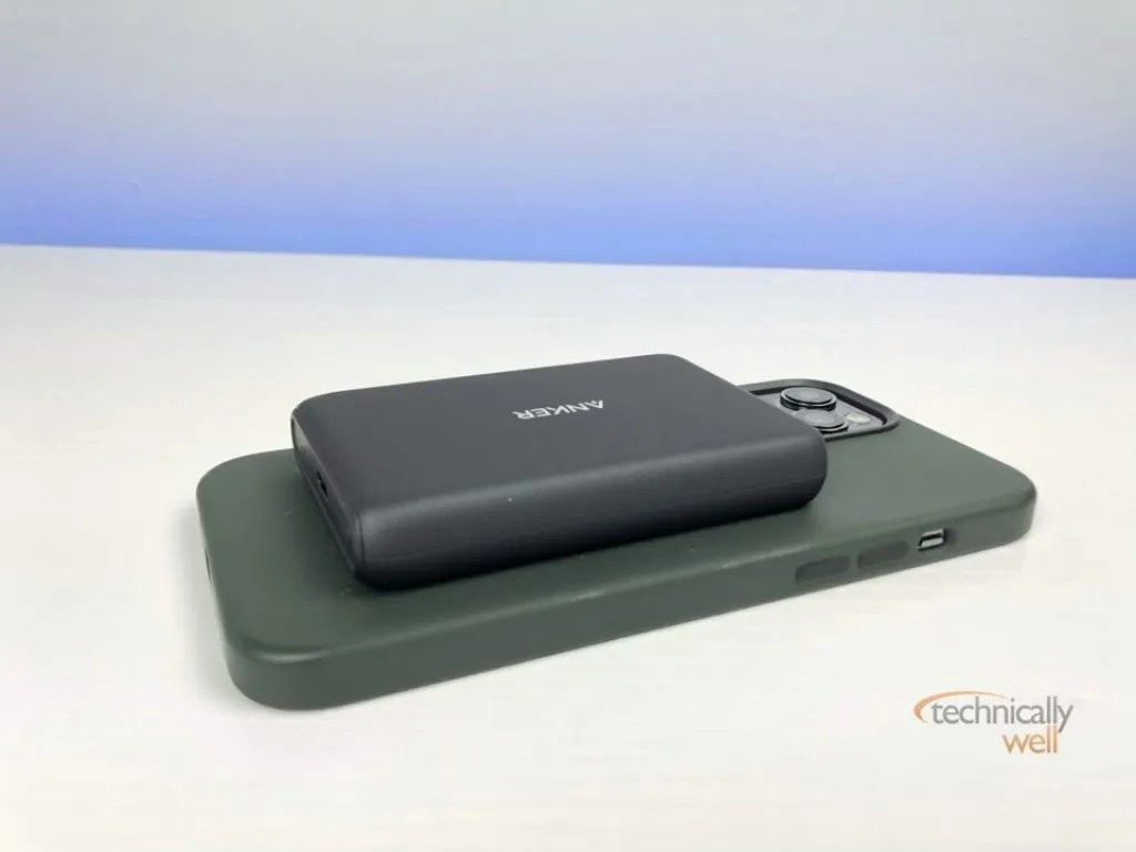 The Anker PowerCore Magnetic 5K Wireless power bank attached to an iPhone 12 Pro Max with silicone case