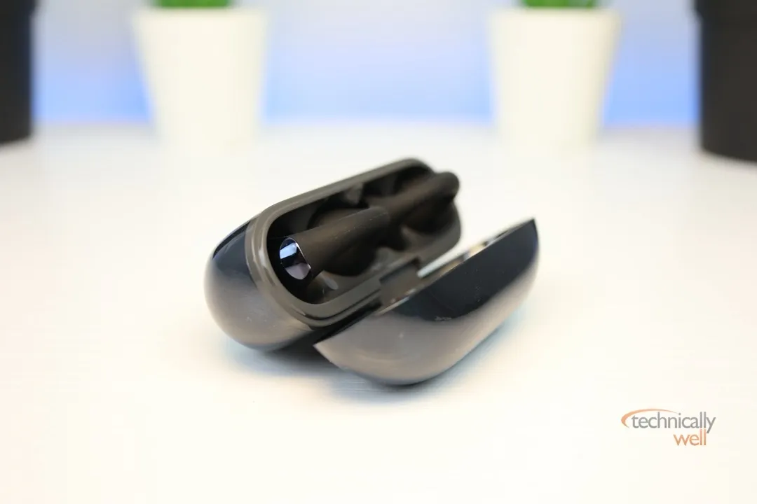 SoundPEATS PearlClip Pro earbuds inside charging case