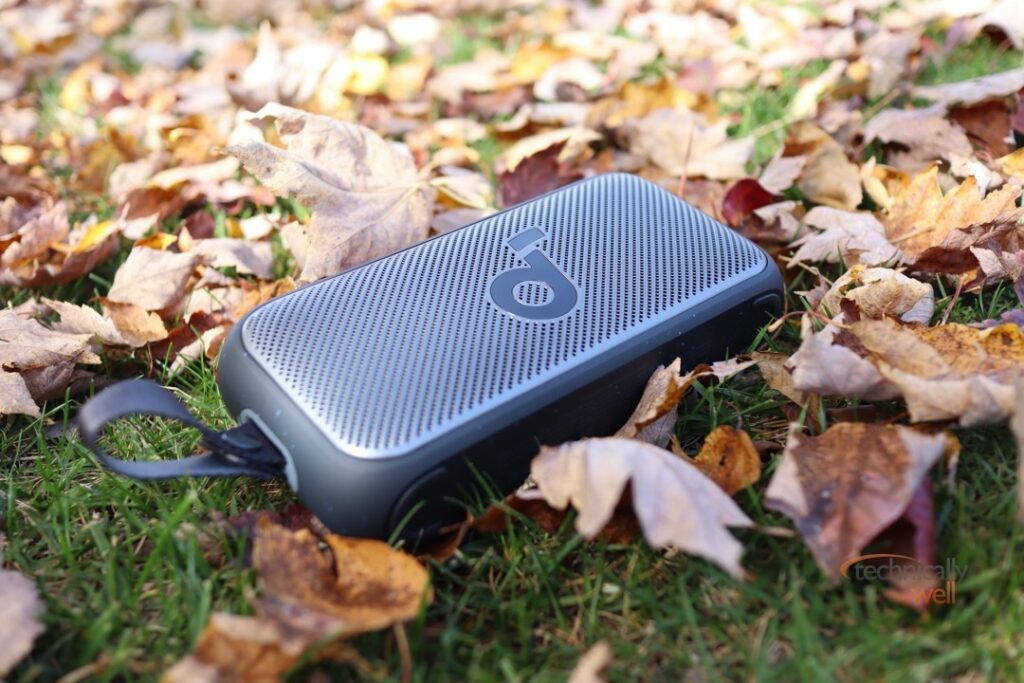 Soundcore Motion 300 laying on the ground in some leaves